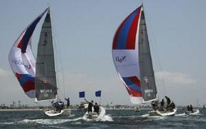 Taylor Canfield (l.) races downwind burdened by two penalty flags - Congressional Cup 2014 photo copyright Rich Roberts taken at  and featuring the  class