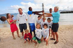 The arrival of the Queen's Baton in the Race Village brought much excitement to the BVI Spring Regatta as organisers secured a visit during its 288-day journey en route to the XX Commonwealth Games in Glasgow, Scotland. Nanny Cay General Manager, Miles Sutherland-Pilch and family (left), local youth sailors and Regatta Chairman, Bob Phillips (right) proudly display the baton.  - BVI Spring Regatta and Sailing Festival 2014 photo copyright Todd VanSickle / BVI Spring Regatta http://www.bvispringregatta.org taken at  and featuring the  class