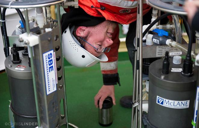 Dan Ohnemus unloads pumps that have sucked in seawater samples containing particles floating in the ocean. He analyzes those particles to reveal the movement of chemicals in the ocean. © Chris Linder