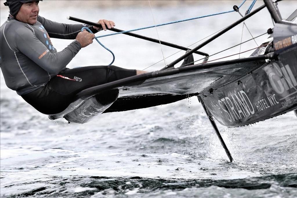 Regatta leader and US National Champ Anthony Kotoun shows his Caribbean background with a few extra items of clothing to help him deal with the 55-degree water.  Newport, RI.2014 © Meredith Block/US Moth Class photo copyright SW taken at  and featuring the  class