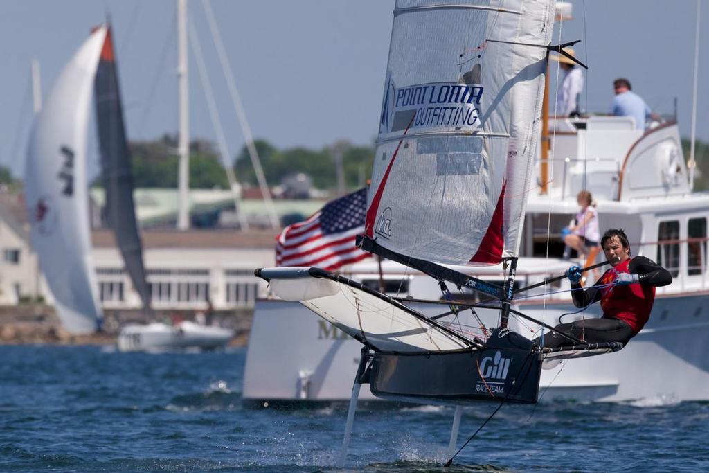 MIT grad student Brooks Reed races hard in front of a busy Newport harbor. Newport, RI.2014 © Meredith Block/US Moth Class photo copyright SW taken at  and featuring the  class