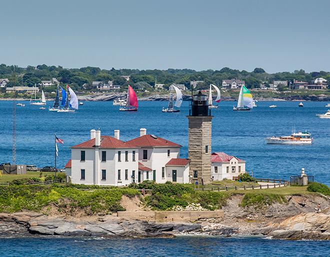 The 2014 Bermuda Race fleet sail past Beavertail lighthouse out into the Atlantic. © Daniel Forster/PPL