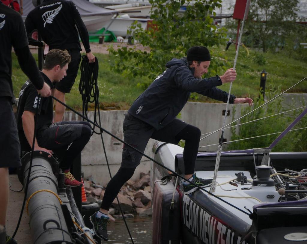 Richard Meacham Jumps on  the boat during the launch of it going in the water in St Petersburg, Russia © Hamish Hooper/Emirates Team NZ http://www.etnzblog.com