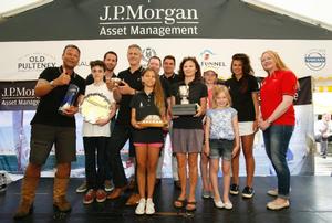 Folkboat Madelaine's skipper Edward Donald (left), crew & the family Donald celebrating winning the Gold Roman Bowl & additional trophies presented by Sir Ben Ainslie at the 2014 J.P. Morgan Asset Management Round the Island Race photo copyright Patrick Eden taken at  and featuring the  class
