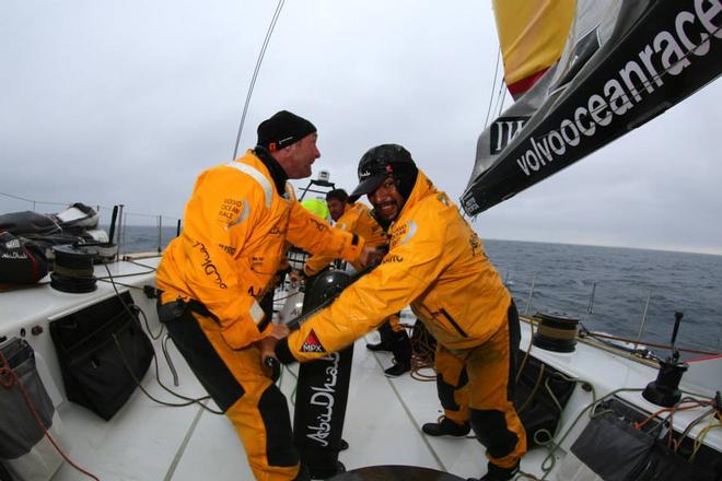 Ian Walker and Adil Khalid grimace with the effort of shaking out a reef in Azzam's mainsail - Abu Dhabi Ocean Racing - Trans Atlantic Return crossing July 2014 © Abu Dhabi Ocean Racing (ADOR) 
