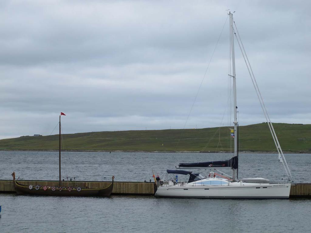 Distant Shores II at pontoon in Lerwick with Viking ship © Paul and Sheryl Shard http://www.distantshores.ca/
