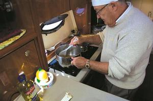 ``John with his nice slacks in the galley``                 - The Galley Guys' favourite shrimp recipe photo copyright The Galley Guys taken at  and featuring the  class