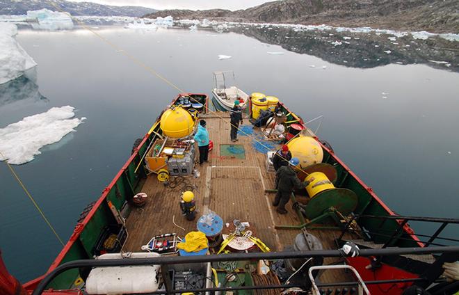 The aft deck of the M/V Viking Madsalex was the staging area to deploy the SF1 mooring in 2011 and for dragging operations to recover it in 2013. Clockwise from left WHOI scientist Magdalena Andres, MIT-WHOI graduate student Rebecca Jackson, WHOI oceanographer Fiamma Straneo, and WHOI mooring technician Will istrom. © Nick Beaird, WHOI