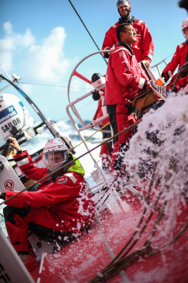 October 24, 2014. Leg one onboard Dongfeng Race Team. Charles Caudrelier, Jin Hao Chen and Martin Strömberg trying to keep themselves upright when the boat is heeling over and water is crashing over the deck - Volvo Ocean Race 2014-15. © Yann Riou / Dongfeng Race Team
