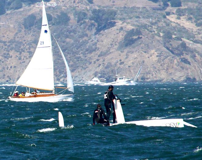 In not their best moment, ASCC crew stands on bottom of their skiff after pitch poling in the last race © Rich Roberts