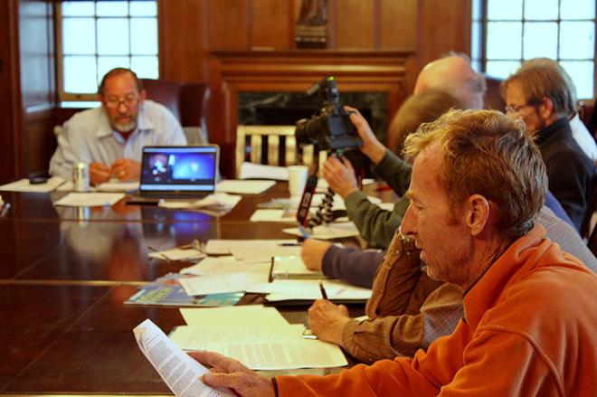 Hank Schmitt (left, background) shares a skype weather briefing with NARC skippers in Newport at Seaman’s Church Institute.  © OPO http://www.sailopo.com/