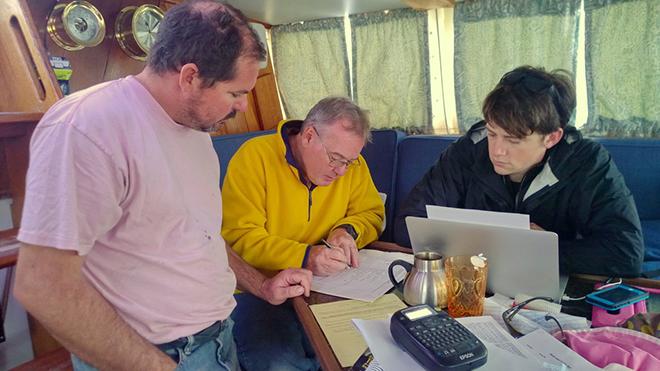 (From left) Salty’s owner/skipper Carl Zaniboni meets with crew Peter Berdoo and Wayne Whiting.  © OPO http://www.sailopo.com/