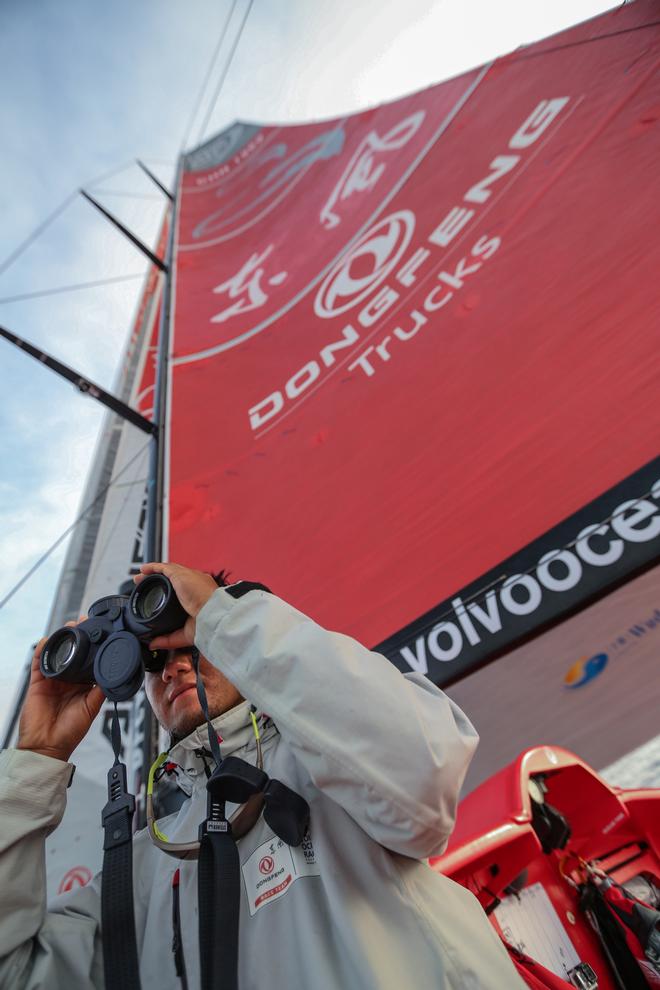 October 28, 2014. Leg one onboard Dongfeng Race Team. Jiru Yang, aka Wolf, controlling the moves of Alvimedica just behind them after 17 days of sailing - Volvo Ocean Race 2014-15. © Yann Riou / Dongfeng Race Team