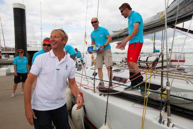 Nick Elliott, RORC Racing Manager greets Bank von Bremen with a much deserved case of beer! - Sevenstar Round Britain and Ireland Race 2014 © Patrick Eden/RORC