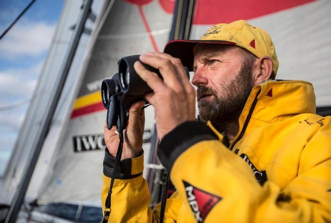 November 4, 2014. Leg 1 onboard Abu Dhabi Ocean Racing. Ian Walker using the binoculars to check out the strategy of Dongfeng to leeward. © Matt Knighton/Abu Dhabi Ocean Racing