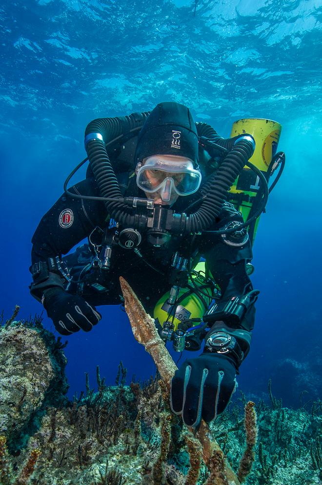 Return to Antikythera project chief diver Philip Short inspects the bronze spear recovered from the Antikythera Shipwreck. © Return to Antikythera 2014