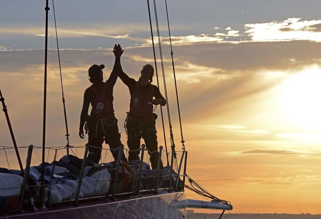 Team SCA finishes at dawn off Cowes to beat the all female round Britain record. SCA skippered by Sam Davies, crossed the finish line of the 2014 Sevenstar Round Britain and Ireland Race off the Royal Yacht Squadron, Cowes at 06.10.39 BST on Satuday 16th August 2014 with an elapsed time of 4 days, 21 hours, 00 minutes and 39 seconds. photo copyright Rick Tomlinson / Team SCA taken at  and featuring the  class
