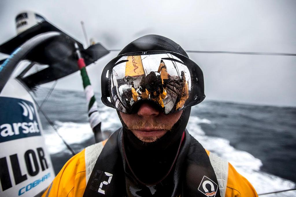 Volvo Ocean Race - November 3, 2014. Leg 1 onboard Abu Dhabi Ocean Racing.  Luke Parkinson with his goggles on, reflecting the camera and watch team working on the boat. © Matt Knighton/Abu Dhabi Ocean Racing