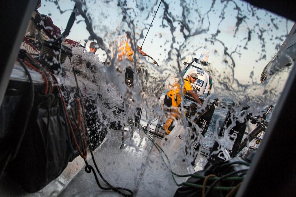 October 18, 2014. Leg 1 onboard Abu Dhabi Ocean Racing. Skipper Ian Walker takes a turn on the pumps as the waves start to buid. © Matt Knighton/Abu Dhabi Ocean Racing