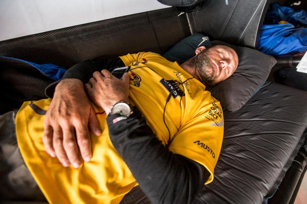 November 4, 2014. Leg 1 onboard Abu Dhabi Ocean Racing. Ian Walker finally spends a few minutes resting after days of being awake and pushing hard for a Leg 1 win; The pressure isn't off yet but they have the advantage over the other boats.  © Matt Knighton/Abu Dhabi Ocean Racing