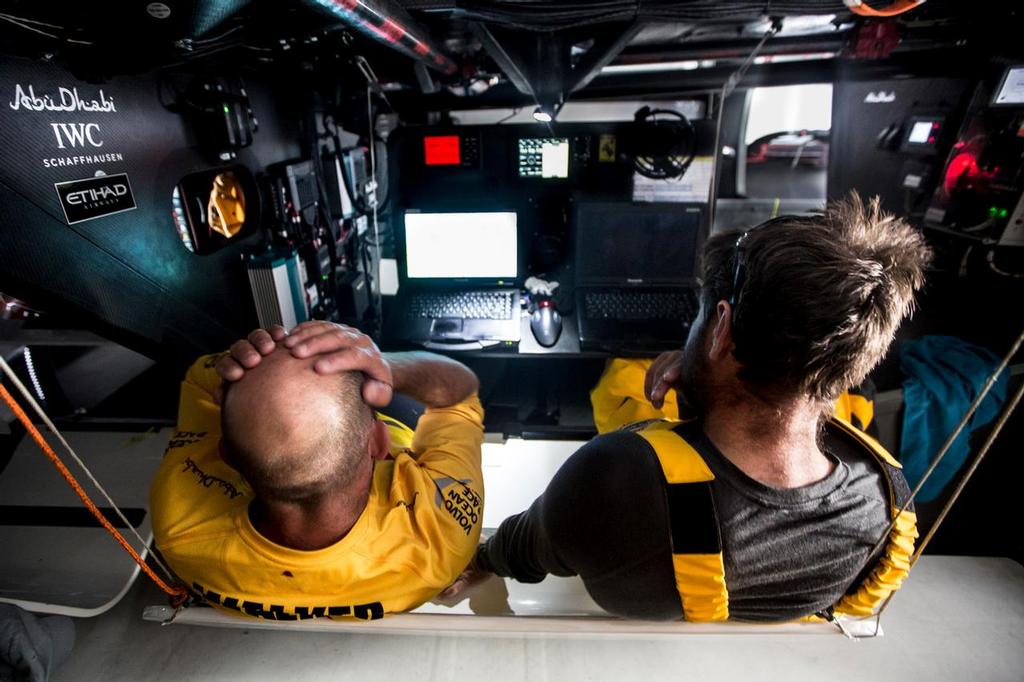 November 4, 2014. Leg 1 onboard Abu Dhabi Ocean Racing. Ian Walker and Simon Fisher sit at the navigation desk discussing strategy for the final day. They're currently in first position but being followed very closely by the other boats; they can't afford to make any mistakes.  © Matt Knighton/Abu Dhabi Ocean Racing
