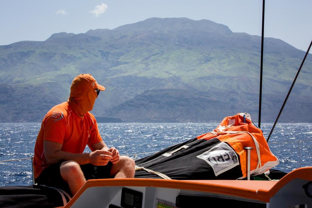 October 19, 2014.  Leg 1 onboard Team Alvimedica. Day 8. Day of the Cape Verdes transit and decision time for the Equator / Doldrums approach. Dave Swete takes in the grandeur of Santa Antao, the westernmost island of the Cape Verdes. ©  Amory Ross / Team Alvimedica
