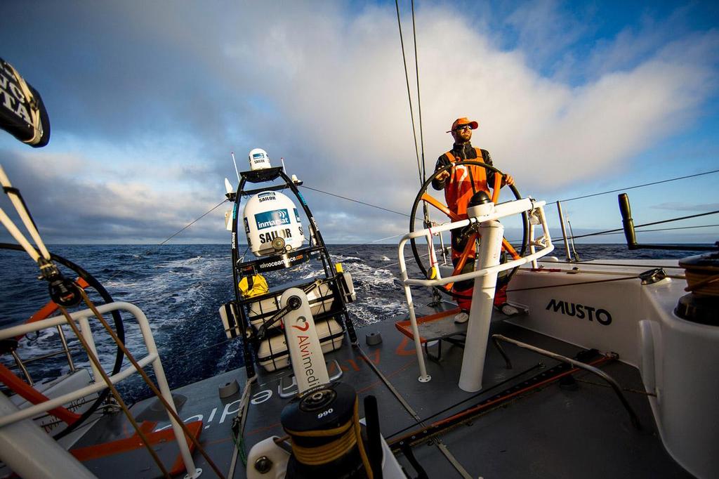 Team Alvimedica. The fleet begins the gradual turn east around the High. Seb Marsset driving at sunrise. ©  Amory Ross / Team Alvimedica