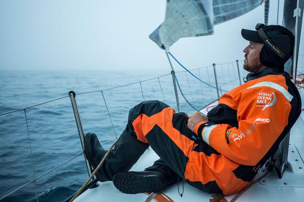 October, 2014. Leg 1 onboard Team Alvimedica. Day 21. Winds lighten and the complicated road to Cape Town begins as the first High pressure system rolls through the fleet. Dave Swete closes his eyes on the bow for a bit after a tiring and frustrating day of light-wind sailing in the South Atlantic, a stretch of water notorious for its strong winds. ©  Amory Ross / Team Alvimedica