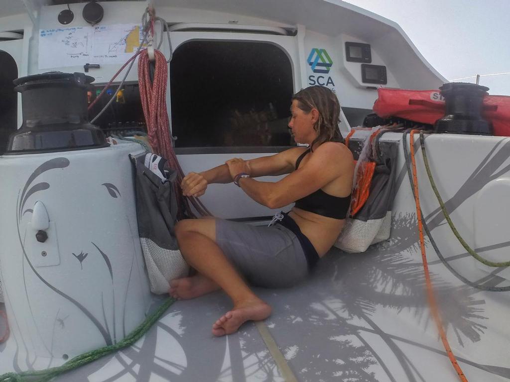 Volvo Ocean Race - October 19, 2014. Leg 1 onboard Team SCA. Liz Wardley ``enjoys`` a bath under the hatch. photo copyright Corinna Halloran / Team SCA taken at  and featuring the  class