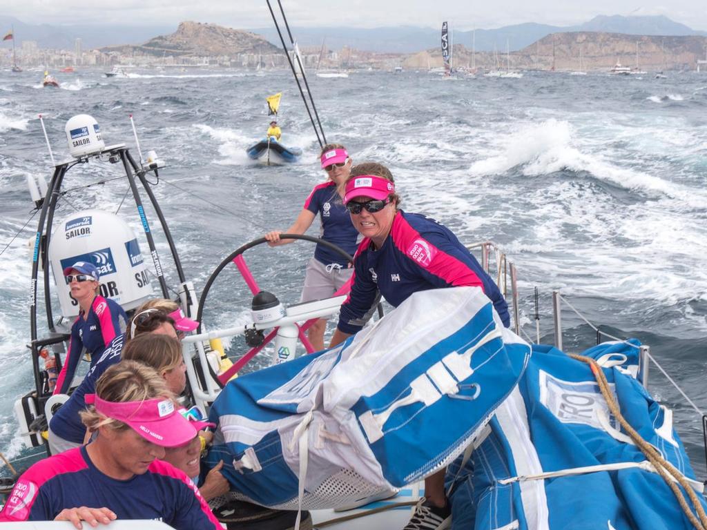 October, 2014. Leg 1 onboard Team SCA.  Sally Barkow helps lift the sail up on to the stack shortly after the start of the 2014-2015 Volvo Ocean Race on board Team SCA. © Corinna Halloran / Team SCA