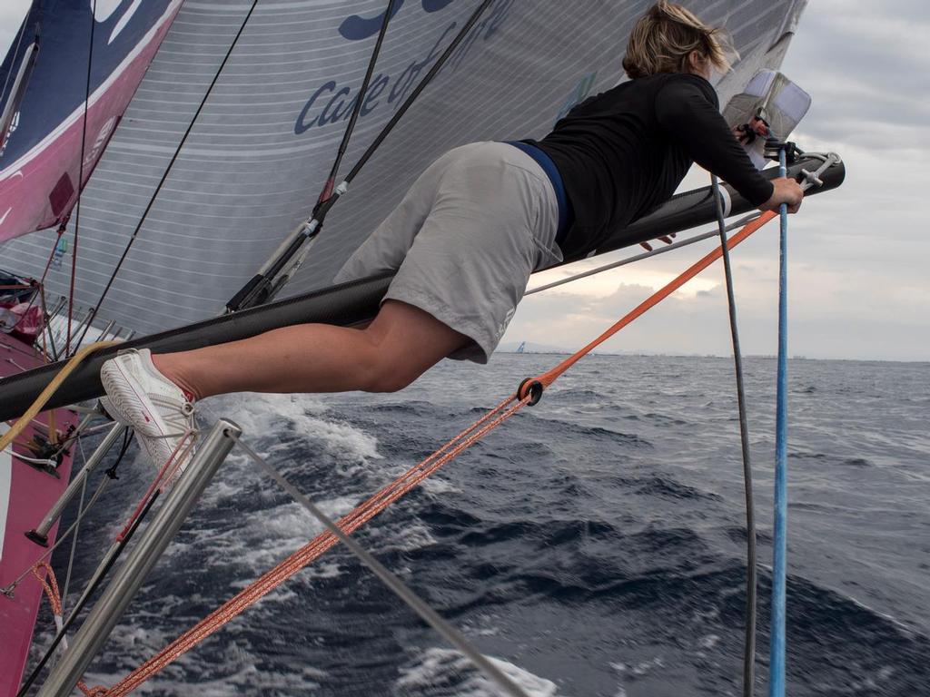 October, 2014. Leg 1 onboard Team SCA. Abby Ehler rigs up the out rigger on the low side with the leading boats in the close distance. photo copyright Corinna Halloran / Team SCA taken at  and featuring the  class