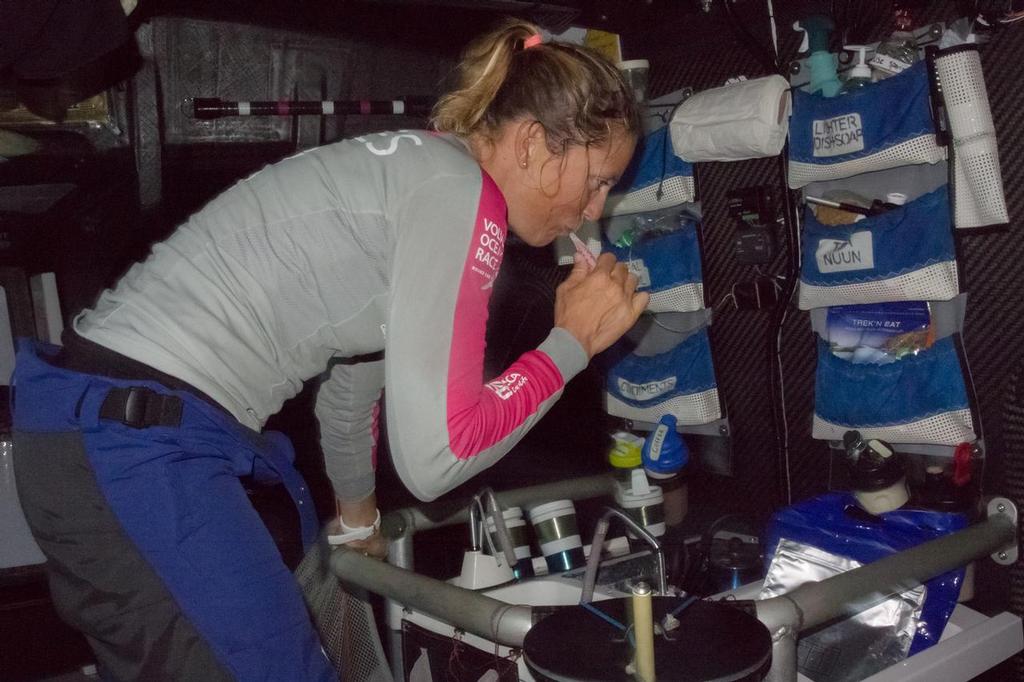 October, 2014. Leg 1 onboard Team SCA. Hygiene is essential out here; Sam Davies takes a moment to brush her teeth after watch. © Corinna Halloran / Team SCA