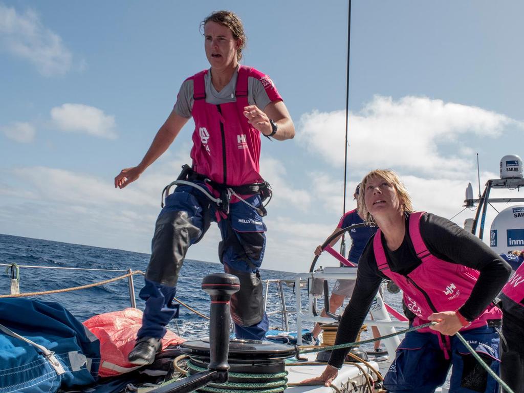 October 19, 2014. Leg 1 onboard Team SCA. Stacey Jackson runs by Abby Ehler after a gybe. © Corinna Halloran / Team SCA