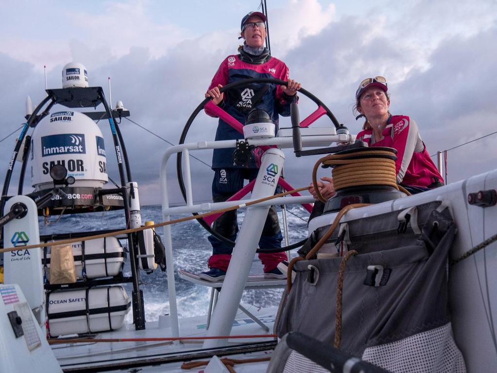 October 27, 2014. Leg 1 onboard Team SCA. Carolijn Brouwer helms at sunrise. photo copyright Corinna Halloran / Team SCA taken at  and featuring the  class