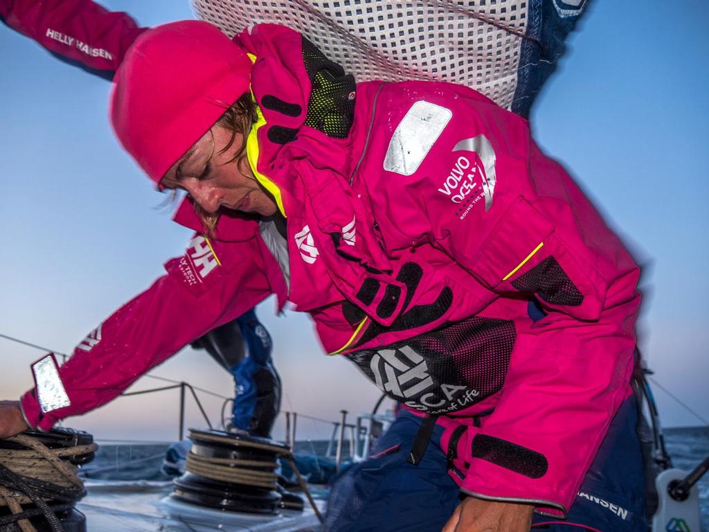 October 31, 2014. Leg 1 onboard Team SCA. Justine Mettraux takes the weight of the sail with her back preparing for a jibe. © Corinna Halloran / Team SCA