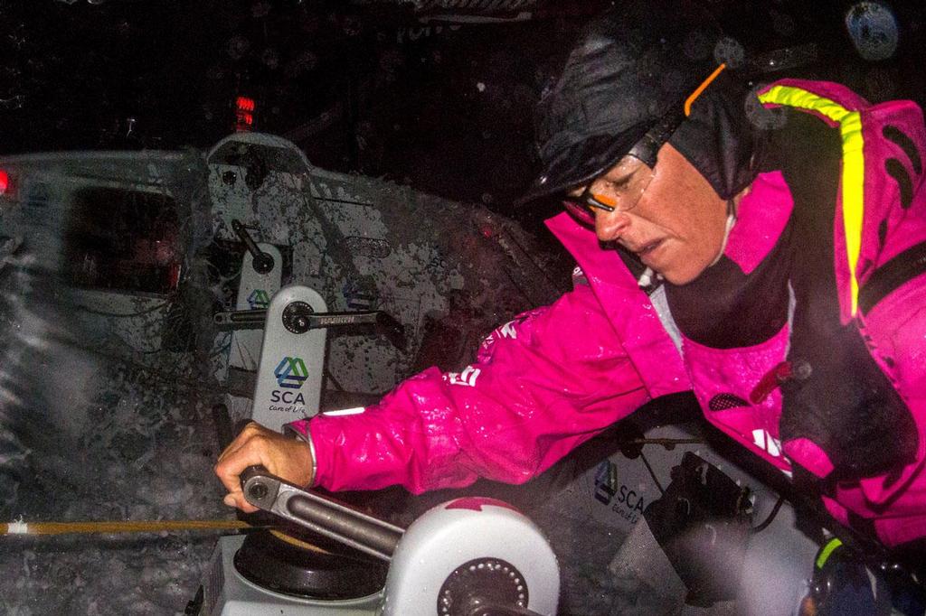 Volvo Ocean Race - November 2, 2014. Leg 1 onboard Team SCA. Carolijn Brouwer grinds as a wave comes over the top. © Corinna Halloran / Team SCA