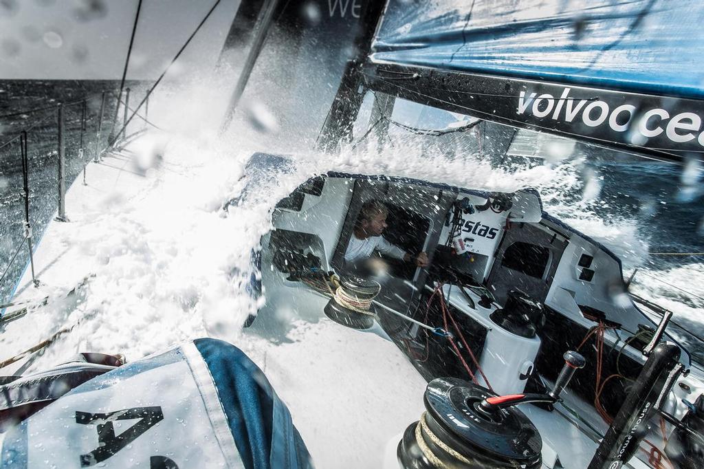 October 18, 2014. Leg 1 onboard Team Vestas Wind. Somewhere under the waves is our boat. Wouter Verbraak  trying to keep dry. © Brian Carlin - Team Vestas Wind