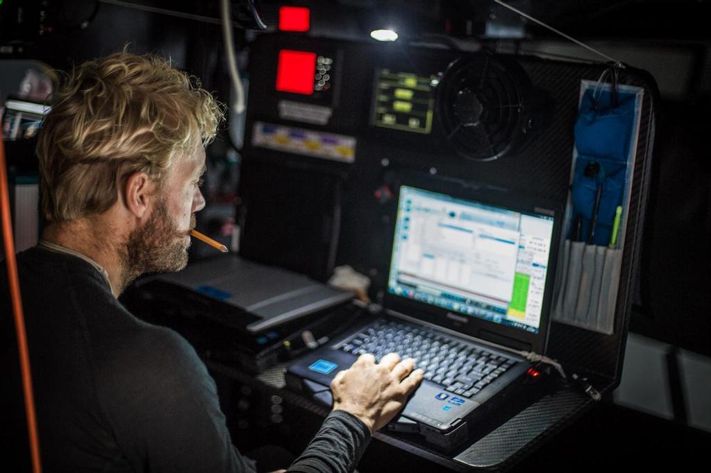 November 01, 2014. Leg 1 onboard Team Vestas Wind.Wouter Verbraak studies the weather models. Day 21 at Sea. photo copyright Brian Carlin - Team Vestas Wind taken at  and featuring the  class