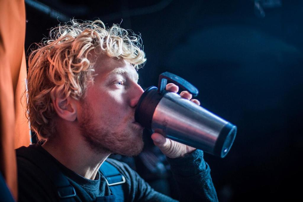 November 04, 2014. Leg 1 onboard Team Vestas Wind. Peter Popp Wibroe stimulates the body with a cup of coffee. Day 24 at Sea, © Brian Carlin - Team Vestas Wind