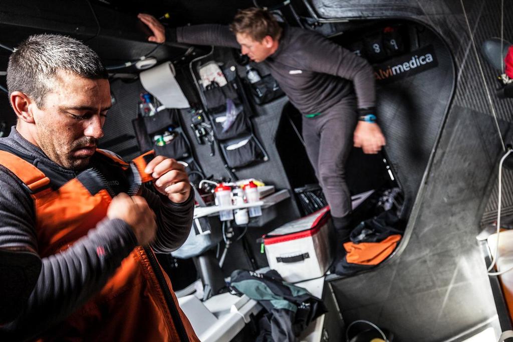 August 14, 2014. Round Britain Island Race Day 4 - OBR content Team Alvimedica: Mark Towill (L) and Dave Swete (R) gearing up to go on deck for their next 4-hour watch. Improving weather means changing to lighter gear, much of which was packed away for the rough start of the RORC's Round Britain and Ireland Race. ©  Amory Ross / Team Alvimedica