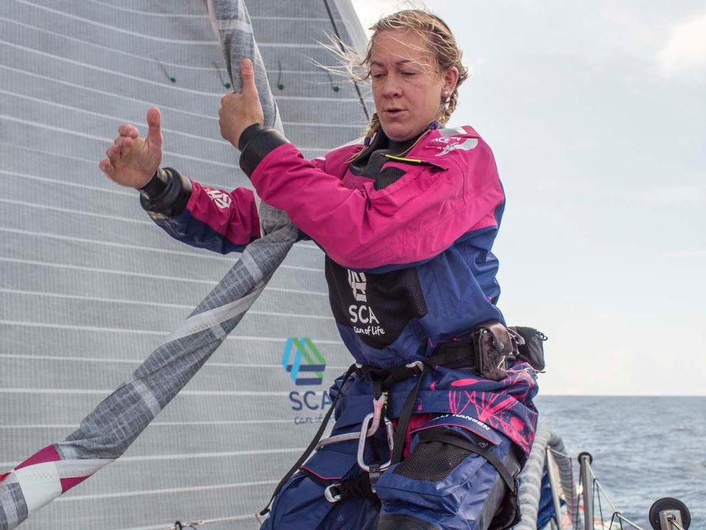 2014-15 Volvo Ocean Race. Leg 1 onboard Team SCA. Sophie Ciszek helps hoist the sail during some unexpected breeze. © Corinna Halloran / Team SCA