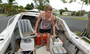 Adam Hugo (15) salvages some footwear and other items from the boat after surviving a harrowing 4 hours with the rest of his family in rough seas clinging to their overturned boat in Keppel Bay before the RACQ Rescue Helicopter came to their aid.  - 13-year-old girl and dad were trapped under boat on Aus Day photo copyright Chris Ison / The Morning Bulletin taken at  and featuring the  class