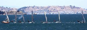18' Skiffs sail through smoke from the starting gun in the middle of San Francisco Bay  - 2014 18' Skiff International Regatta photo copyright Rich Roberts taken at  and featuring the  class