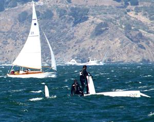 In not their best moment, ASCC crew stands on bottom of their skiff after pitch poling in the last race photo copyright Rich Roberts taken at  and featuring the  class