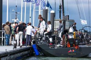 The yacht's designer, Jason Ker, spectators and the RORC Race team on the dock to greet the crew of Varuna at Trinity Landing, Cowes after the finish. 2014 Sevenstar Round Britain and Ireland Race. photo copyright Hamo Thornycroft http://www.yacht-photos.co.uk taken at  and featuring the  class