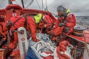 Dongfeng crew hard at work - 2014 Sevenstar Round Britain and Ireland Race photo copyright Dongfeng Race Team taken at  and featuring the  class