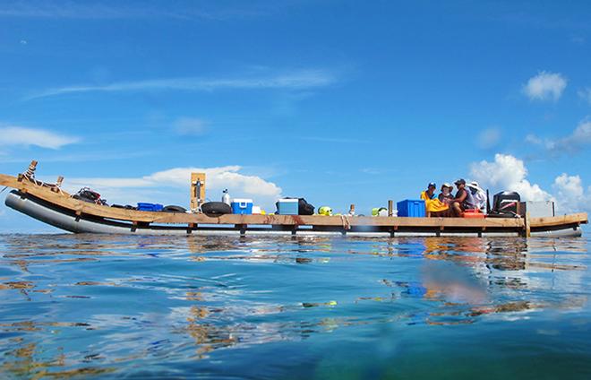 To study corals in the South China Sea, WHOI scientists set up a makeshift floating lab, strapping wooden planks across plastic tubes.  © Kathryn Pietro, WHOI
