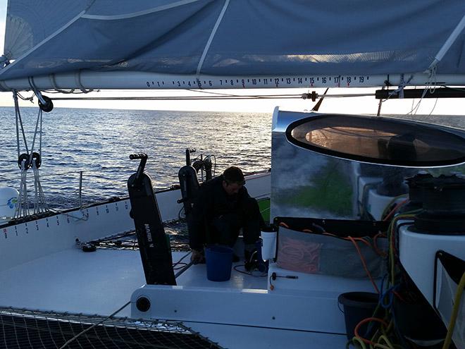 Sam on the hand pump water maker while we repaired the permanent one on board. © Henry Bomby