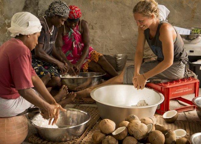 Charlotte Leger helps the women in Buma shred coconut. Photos courtesy of Britt Basel - OceansWatch Climate Change adaptation program - Solomon Islands © OceansWatch www.oceanswatch.org