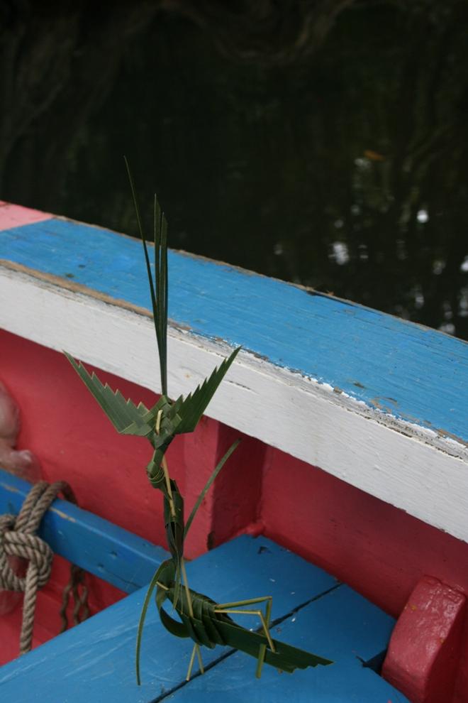 While enjoying a ‘dynamite’ at the Bush Bar, Sparrow makes us origami out of palm fronds. - Dominica By Elizabeth A. Kerr © Elizabeth A Kerr